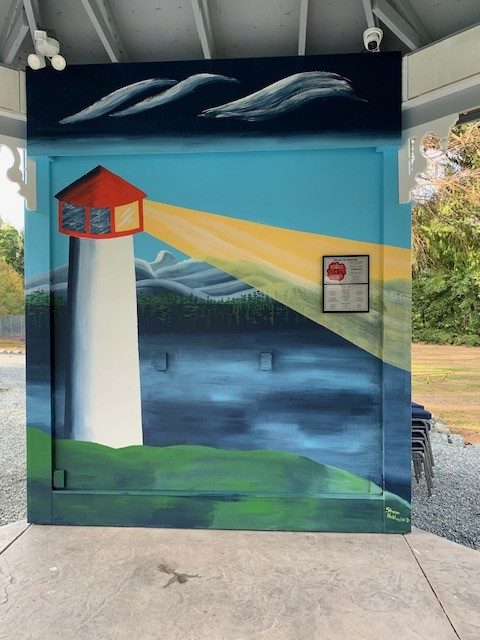 A painted mural of a lighthouse beaming light over the water, inside the gazebo.